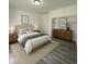 Calm bedroom with neutral color scheme, wood furniture, and natural light, creating a relaxing atmosphere at 2111 Central Ave, Anderson, IN 46016