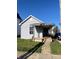 Charming single-story home with a covered porch and vinyl siding, located on a sunny lot at 2111 Central Ave, Anderson, IN 46016