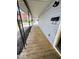 Covered porch with wood flooring, rod iron supports, a mailbox, and an outlet at 2111 Central Ave, Anderson, IN 46016