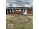 View of the brick house exterior, a yard, and an old above-ground pool area at 2146 Lawrence Ave, Indianapolis, IN 46227