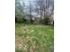 Grassy backyard with a wrought iron fence and a partially visible house at 2146 Lawrence Ave, Indianapolis, IN 46227