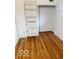 A bedroom featuring hardwood flooring, a shelving unit, and a closet at 2146 Lawrence Ave, Indianapolis, IN 46227