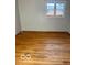 The bright bedroom featuring a window and beautiful hardwood floors at 2146 Lawrence Ave, Indianapolis, IN 46227