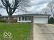 Charming single-story home with a well-maintained lawn and a two-car garage at 2146 Lawrence Ave, Indianapolis, IN 46227