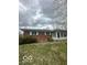 Brick home exterior with a sunroom addition and a well-maintained lawn at 2146 Lawrence Ave, Indianapolis, IN 46227