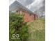 Red brick home with a well-maintained lawn and mature landscaping at 2146 Lawrence Ave, Indianapolis, IN 46227