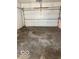 Spacious garage with a white door, needing cleaning and renovation at 2146 Lawrence Ave, Indianapolis, IN 46227