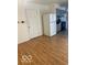 Galley kitchen featuring white appliances and light wood look floors at 2146 Lawrence Ave, Indianapolis, IN 46227