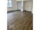 Open living area with light gray wood look floors and bright double window at 2146 Lawrence Ave, Indianapolis, IN 46227