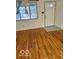 Bright living room featuring hardwood floors and a view of the front door and window at 2146 Lawrence Ave, Indianapolis, IN 46227
