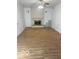 Spacious living room with brick fireplace and mantle and light wood look floors at 2146 Lawrence Ave, Indianapolis, IN 46227