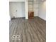 Living area with light gray wood look floors and storage cabinet with shelving at 2146 Lawrence Ave, Indianapolis, IN 46227