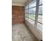 Enclosed patio with brick wall and large windows, perfect for enjoying the outdoors at 2146 Lawrence Ave, Indianapolis, IN 46227