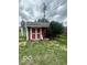 Backyard red shed with white trim, located near green shrubbery at 2146 Lawrence Ave, Indianapolis, IN 46227
