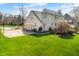 Backyard view highlighting the home's exterior, lush lawn, and mature trees creating a private oasis at 2170 Running Brook Ln, Greenwood, IN 46143