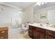 Well-lit bathroom with a shower-tub combo, vanity, and updated fixtures at 2170 Running Brook Ln, Greenwood, IN 46143