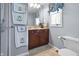 Bathroom featuring granite sink, large mirror, and towel racks at 2170 Running Brook Ln, Greenwood, IN 46143