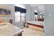 Bathroom featuring a large garden tub, window with black valance, and decorative mermaid at 2170 Running Brook Ln, Greenwood, IN 46143