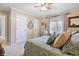 Relaxing bedroom featuring a ceiling fan, plush pillows, and a window with natural light at 2170 Running Brook Ln, Greenwood, IN 46143