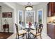 Bright breakfast nook with windows overlooking the backyard, and a decorative chandelier at 2170 Running Brook Ln, Greenwood, IN 46143