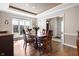 Bright dining room with large window, wood table, and elegant trim at 2170 Running Brook Ln, Greenwood, IN 46143
