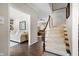Inviting foyer with hardwood floors, staircase, and view into the living room at 2170 Running Brook Ln, Greenwood, IN 46143