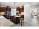 Kitchen features dark cabinetry, stainless steel appliances, and an island with barstool seating at 2170 Running Brook Ln, Greenwood, IN 46143