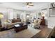 Bright living room with hardwood floors, fireplace, comfortable seating and backyard views at 2170 Running Brook Ln, Greenwood, IN 46143