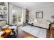 Bright living room featuring a comfortable sofa, elegant rug, and french doors to the outside at 2170 Running Brook Ln, Greenwood, IN 46143