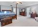 Bright main bedroom featuring four-poster bed, ceiling fan, and an ensuite bathroom at 2170 Running Brook Ln, Greenwood, IN 46143