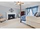 Spacious main bedroom with a fireplace, four-poster bed, and abundant natural light at 2170 Running Brook Ln, Greenwood, IN 46143