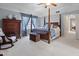 Lovely main bedroom with a four-poster bed, ample natural light, and a vintage trunk at 2170 Running Brook Ln, Greenwood, IN 46143