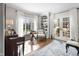 Comfortable home office with hardwood floors, French doors to yard, and built-in shelving at 2170 Running Brook Ln, Greenwood, IN 46143