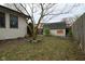 Fenced backyard featuring a tree, shed, and ample space for outdoor activities or gardening at 218 Demarest Dr, Indianapolis, IN 46214