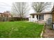Green backyard with a blooming tree and a shed at 218 Demarest Dr, Indianapolis, IN 46214