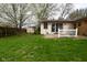 Green backyard with a blooming tree and a shed at 218 Demarest Dr, Indianapolis, IN 46214