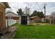 Green backyard showing grass, shed, and white fence at 218 Demarest Dr, Indianapolis, IN 46214