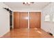 Hardwood floor bedroom with large closets and natural light offering a relaxing and organized space at 218 Demarest Dr, Indianapolis, IN 46214