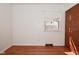 Bright bedroom featuring hardwood floors, a window with blinds, and a closet for ample storage at 218 Demarest Dr, Indianapolis, IN 46214