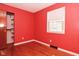 A bright bedroom featuring hardwood floors, a closet, and a window bringing in natural light at 218 Demarest Dr, Indianapolis, IN 46214