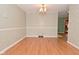 Bright dining room featuring hardwood floors, decorative chandelier, and neutral wall colors at 218 Demarest Dr, Indianapolis, IN 46214