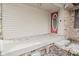 Covered front porch featuring a red front door, vinyl siding, and a poured concrete step at 218 Demarest Dr, Indianapolis, IN 46214