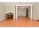 Spacious living room with hardwood floors, and a decorative architectural columned opening to the dining room at 218 Demarest Dr, Indianapolis, IN 46214