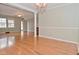Bright living room featuring hardwood floors, a ceiling fan, and architectural columns at 218 Demarest Dr, Indianapolis, IN 46214