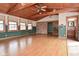 A large living room with wood floors, wood ceiling, with a view to a bathroom at 218 Demarest Dr, Indianapolis, IN 46214