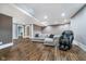 Spacious finished basement with a gray sofa, massage chair, and hardwood floors at 2353 Woodcreek Crossing Blvd, Avon, IN 46123