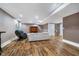 Finished basement with hardwood floors, a white sofa, and a massage chair at 2353 Woodcreek Crossing Blvd, Avon, IN 46123