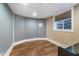 Finished basement room with wood floors, small window, and neutral paint at 2353 Woodcreek Crossing Blvd, Avon, IN 46123