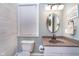 Charming powder room with custom vanity, unique mirror, and neutral color palette at 2353 Woodcreek Crossing Blvd, Avon, IN 46123