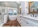 Bright bathroom with soaking tub, stand up shower, double vanity and wood look floors at 2353 Woodcreek Crossing Blvd, Avon, IN 46123